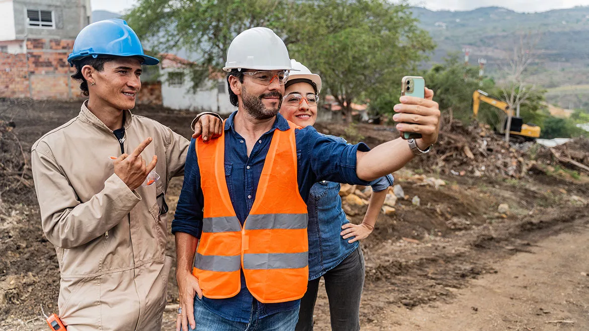 Construction workers taking a selfie at a construction site