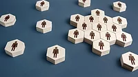 Hexagon wooden shapes with a male gender symbol spread out on a blue table.