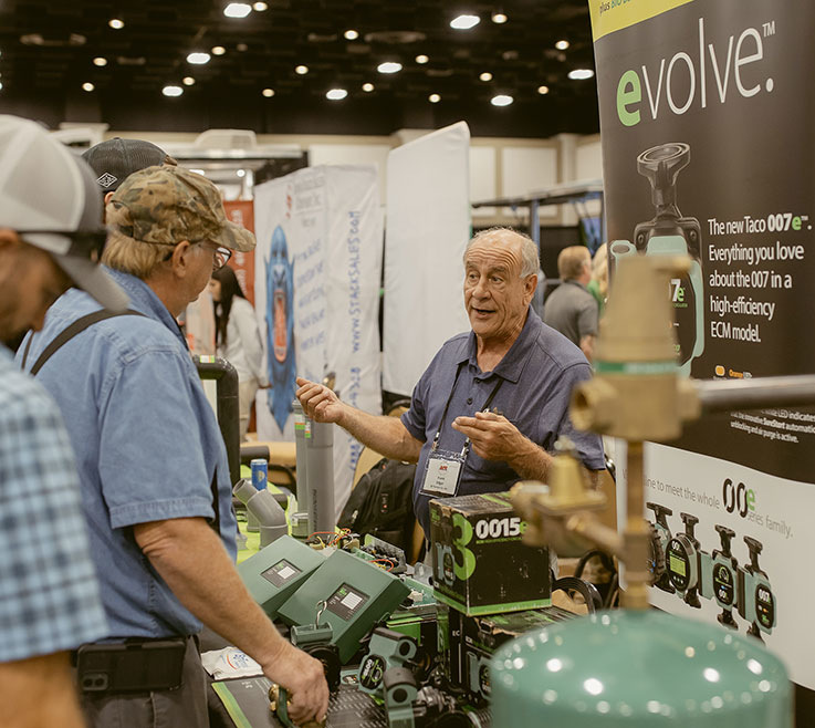 Vendor for Taco's 007e talking with attendees of the APR’s Annual Buying Show