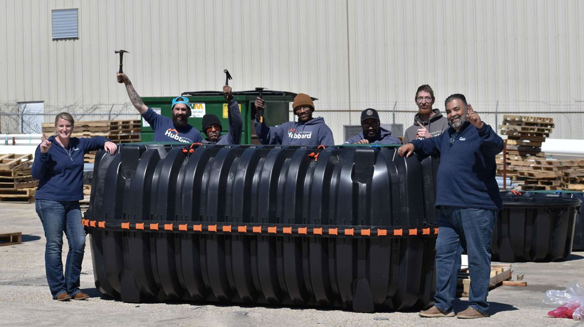 The Hubbard Team posting next to a septic tank during a hands-on training with Infiltrator.