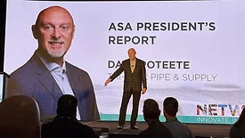 Dave Poteete on stage speaking his final address as ASA President at the NETWORK conference. A large image of him in the background.