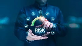 Blurred image if a Man pressing on a digital risk management gage surrounded by business-related icons.