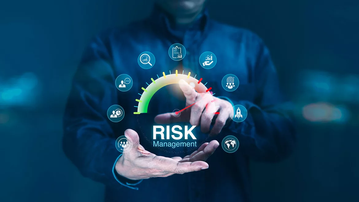 Blurred image if a Man pressing on a digital risk management gage surrounded by business-related icons.