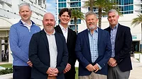 Five distributors who participated in Supply House Times’ 16th annual distributor roundtable are standing outside of a building in Fort Lauderdale, Florida.