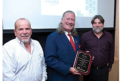 Sid Harvey (left) and Sid Harvey Vice President of Purchasing Rich Carbonaro present Taco CEO and President Johnny White