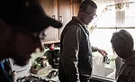 A local plumbing contractor installs a filter in a Flint resident's home