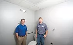 Dan New (left) stands with installing contractor Ryan Hendershott; distrubution, branch, toilet, Mid-City Supply