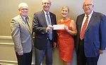 San Jacinto College’s Kevin Morris (second from left) and Ruth Keenan (second from right) display a scholarship check for $25,000 at the PVF Roundtable’s fall meeting in Houston