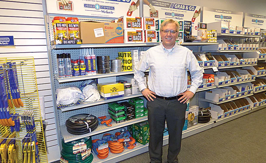 Jones Stephens Vice President of Field Sales Christopher Rohling stands in front of an MRO and contractor specialties display.