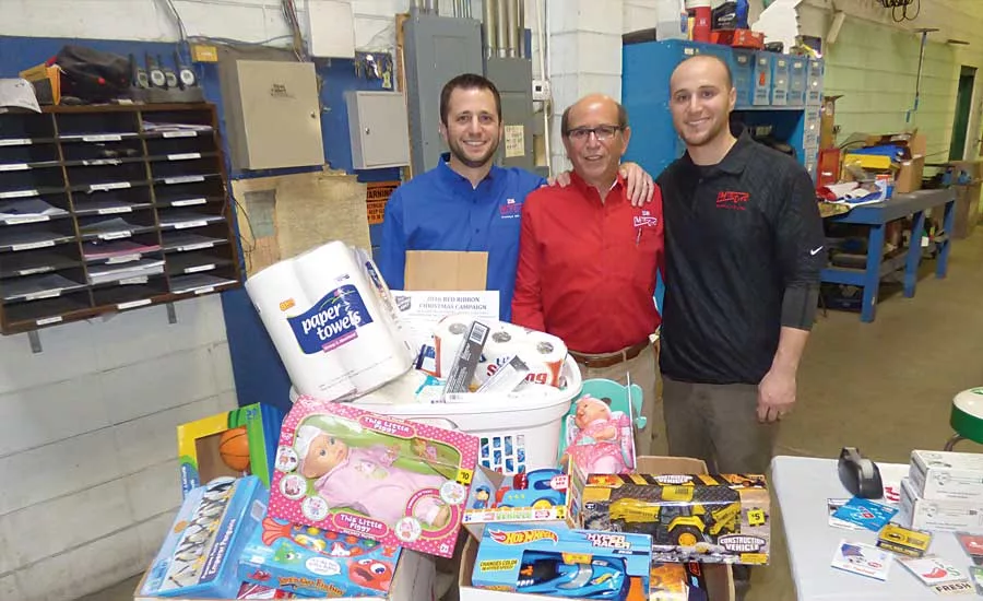 From left: Mid-City Supply’s Dan New, Jeff New and Jordan New at the company’s hog roast event in Elkhart, Ind