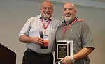 NCWA President Toby Morris (Etna Supply) honors Robertson Heating Supply’s Scott Middleton