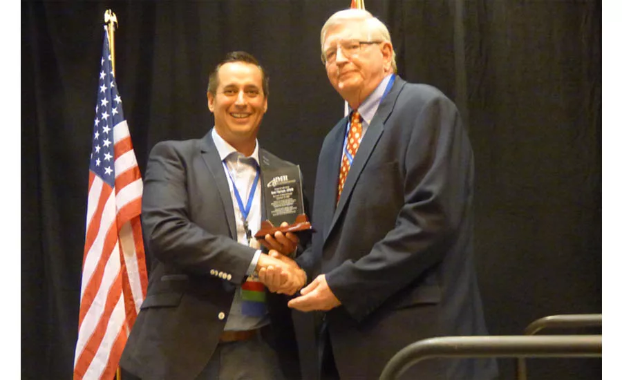 Brian Morgan (left) presents the AIM/R Hall of Fame award to Tom Tiernan