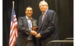 Brian Morgan (left) presents the AIM/R Hall of Fame award to Tom Tiernan