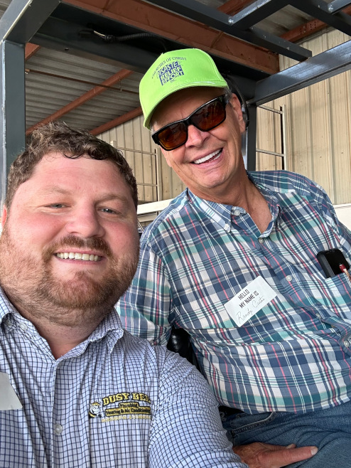 Brock Dugger, director of marketing and public relations for Busy Bee Plumbing, Heating & Air Conditioning, poses for a picture with another Churches of Christ Disaster Relief volunteer.